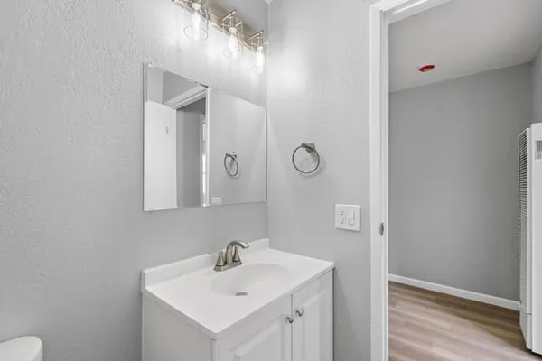 a bathroom with a sink mirror and vanity