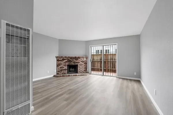 wooden floor in an empty room with a fireplace