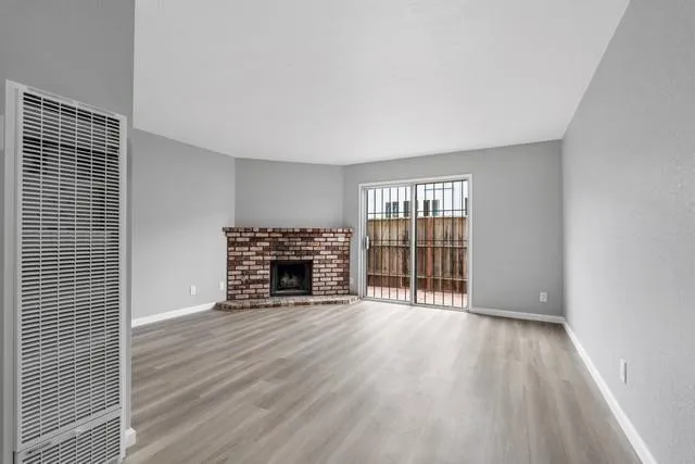 wooden floor in an empty room with a fireplace