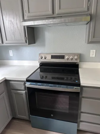 a stove top oven sitting inside of a kitchen