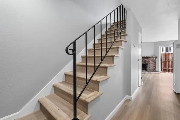 a view of entryway and hall with wooden floor