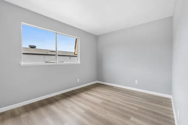 a view of a room with wooden floor and cabinet