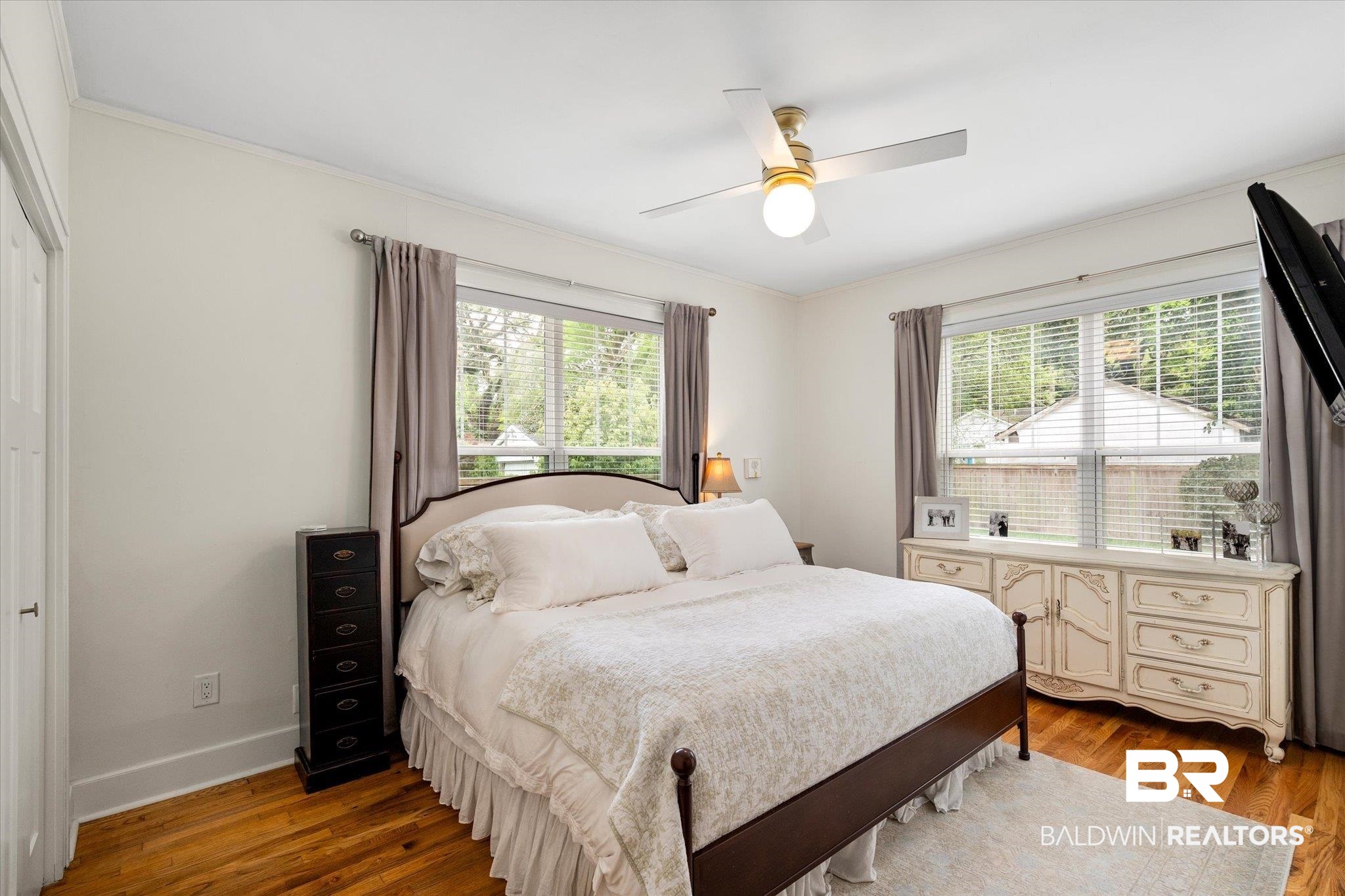 112 Crenshaw Street Mobile, AL 36606 - Photo 11 of 21 Bedroom with baseboards, multiple windows, wood finished floors, and a ceiling fan