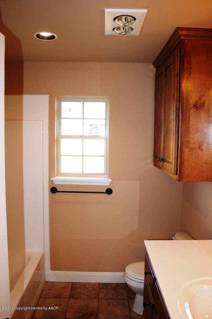 5804 South Rusk Street Amarillo, TX 79118 - Photo 12 of 18 a bathroom with a sink a toilet and shower