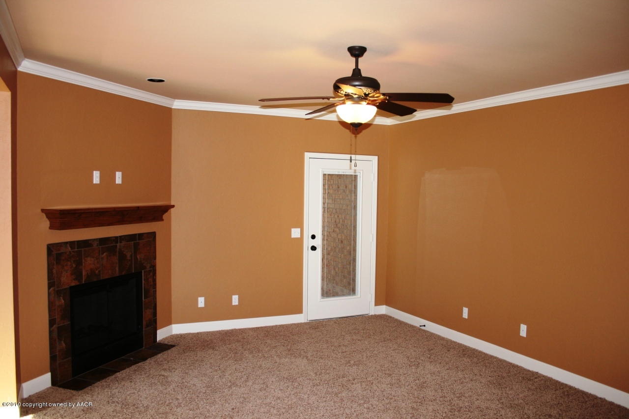 5804 South Rusk Street Amarillo, TX 79118 - Photo 4 of 18 a view of a room with a hanging light and fireplace