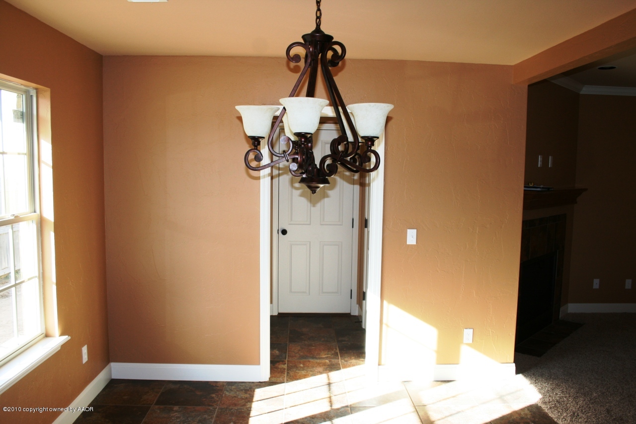 5804 South Rusk Street Amarillo, TX 79118 - Photo 6 of 18 a view of a hallway with windows and chandelier