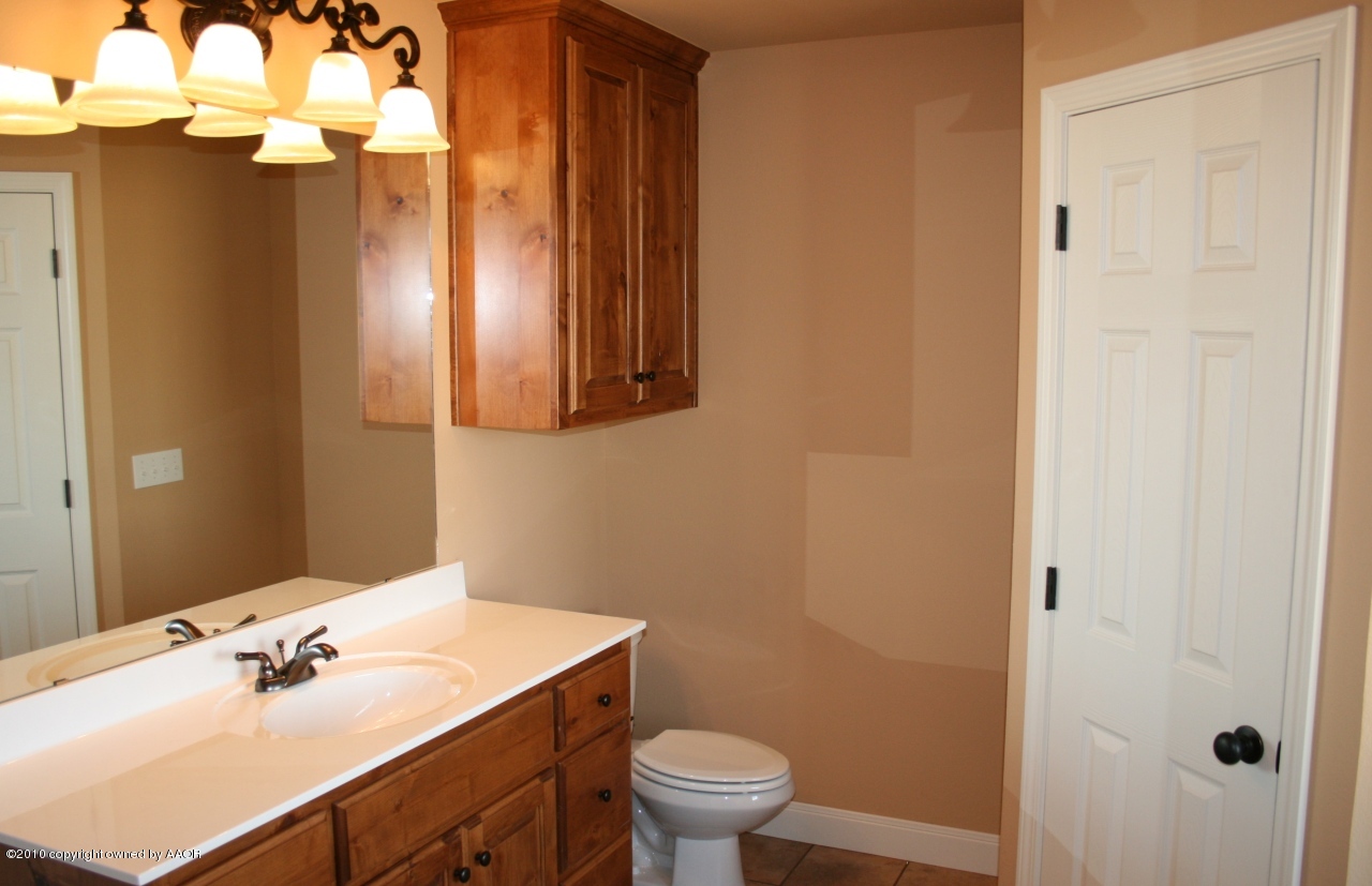5804 South Rusk Street Amarillo, TX 79118 - Photo 8 of 18 a bathroom with a sink a toilet and shower