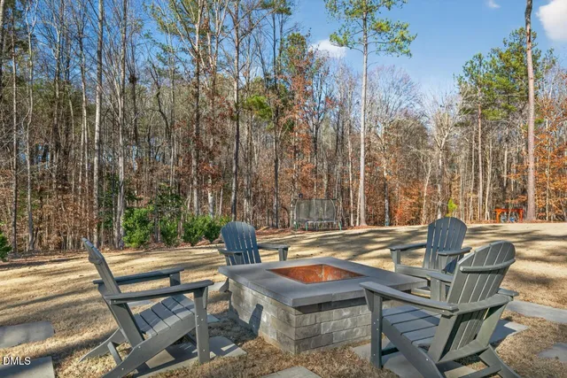 a view of patio with lawn chairs and wooden fence