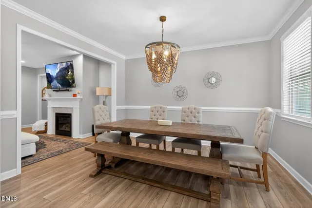a living room with furniture a fireplace and a window