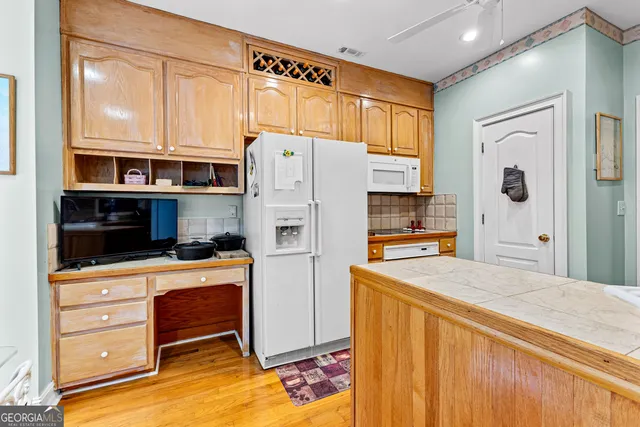 a kitchen with stainless steel appliances a refrigerator and a stove
