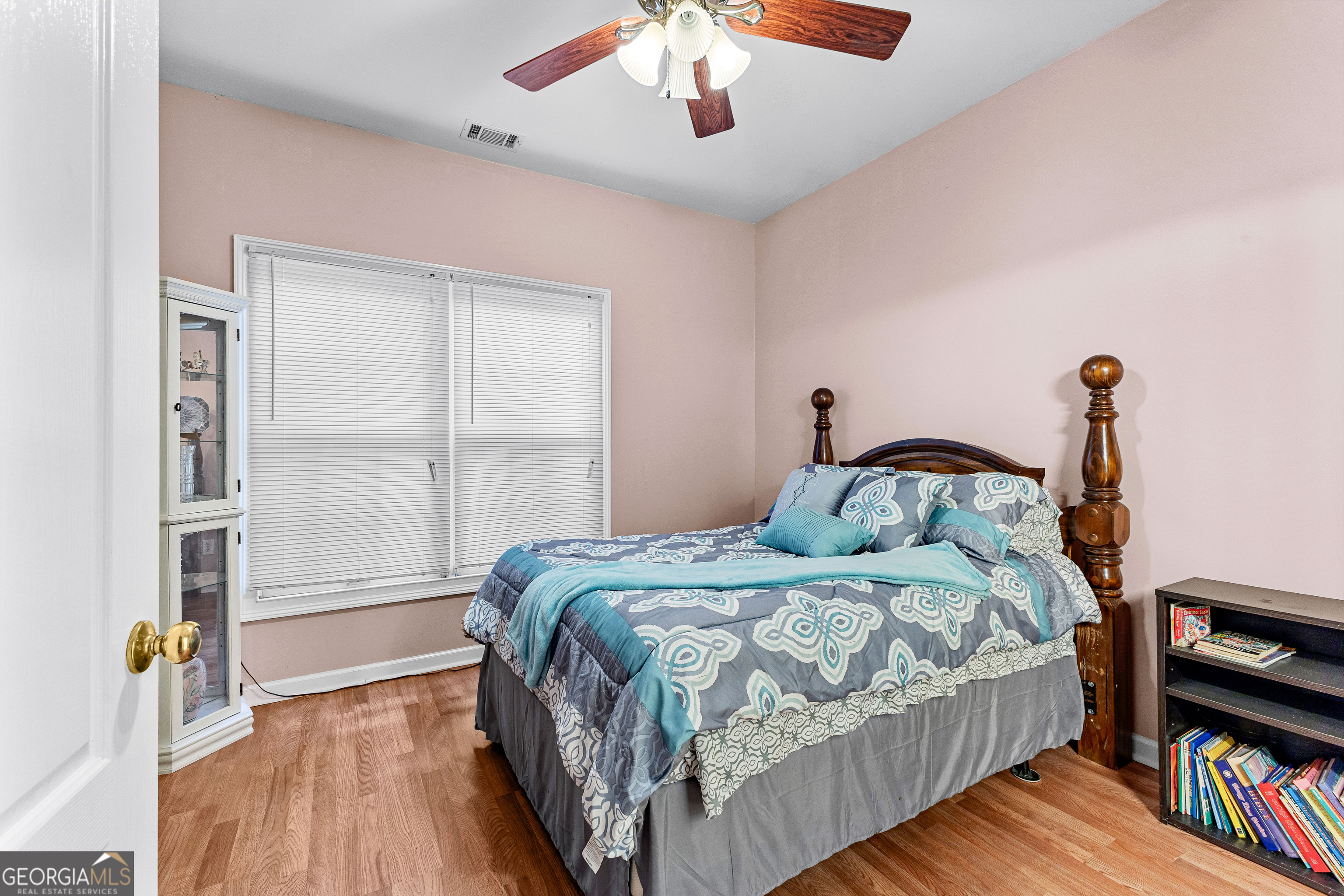 502 North Rover Road Williamson, GA 30292 - Photo 20 of 42 a bedroom with a bed and a book shelf