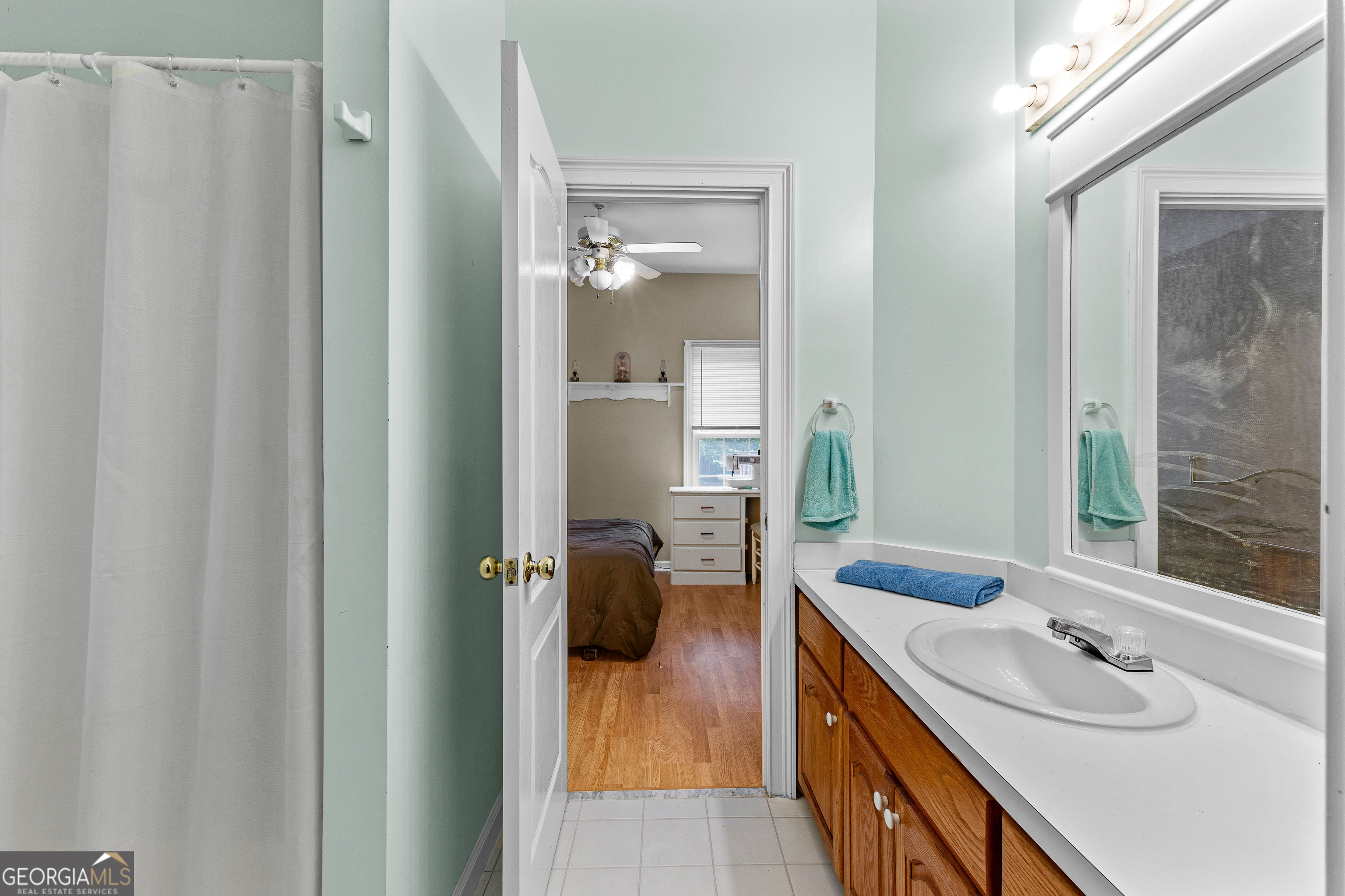 502 North Rover Road Williamson, GA 30292 - Photo 22 of 42 a en suite bathroom with a sink a mirror and a shower