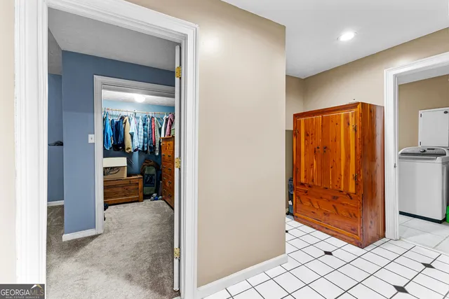 a view of a hallway and a livingroom with furniture
