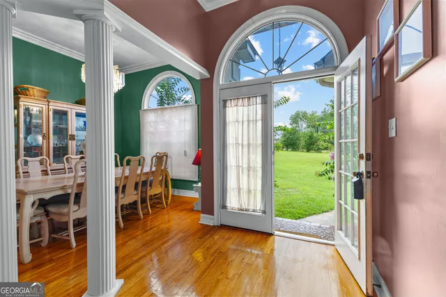 a view of an entryway with wooden floor