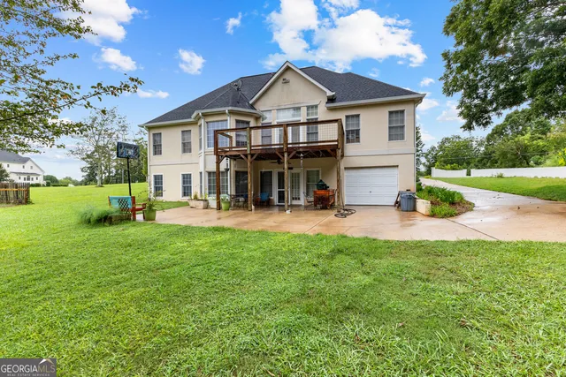 a view of a house with a yard patio and fire pit