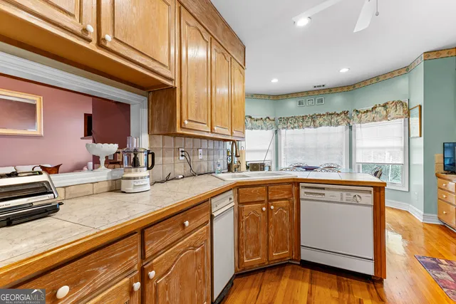 a kitchen with stainless steel appliances granite countertop a sink and cabinets