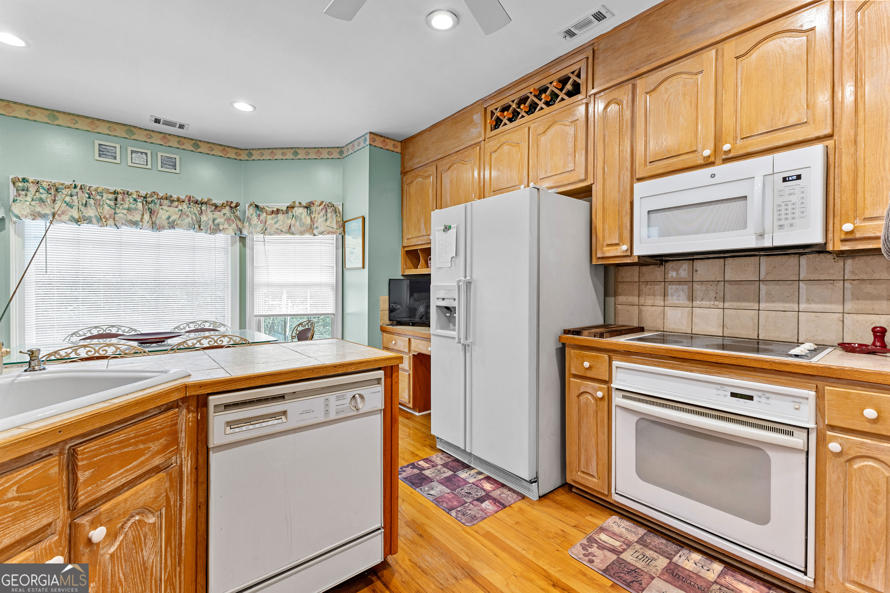 502 North Rover Road Williamson, GA 30292 - Photo 10 of 42 a kitchen with stainless steel appliances a refrigerator sink and cabinets