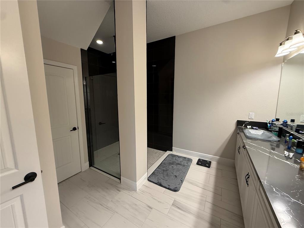 10958 Rustic Timber Loop San Antonio, FL 33576 - Photo 29 of 48 a bathroom with a sink and a mirror