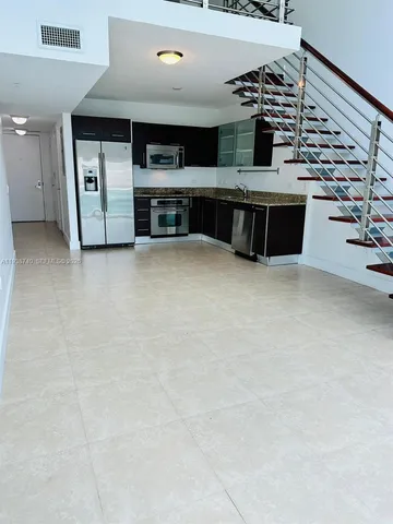 a kitchen with stainless steel appliances a refrigerator and a stove