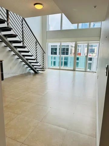 a view of an empty room with stairs