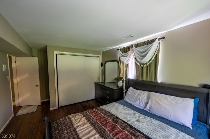13 Village Way, Unit E7 Vernon, NJ 07462 - Photo 13 of 46 a bedroom with a bed mirror and a window