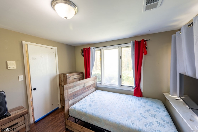13 Village Way, Unit E7 Vernon, NJ 07462 - Photo 18 of 46 a bedroom with a bed and wooden floor