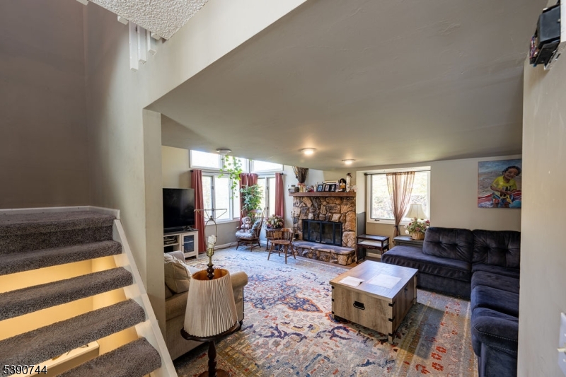 13 Village Way, Unit E7 Vernon, NJ 07462 - Photo 5 of 46 a living room with furniture and a flat screen tv