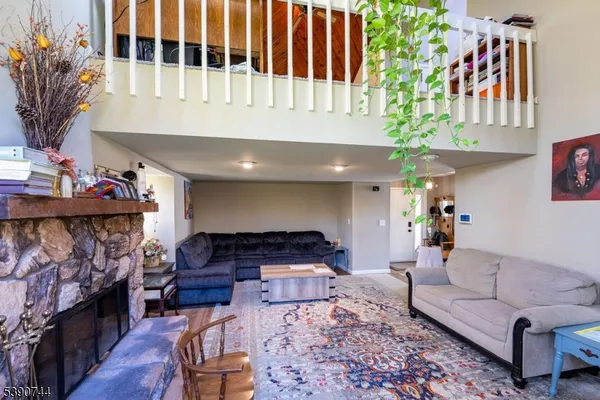a living room with furniture and a fireplace