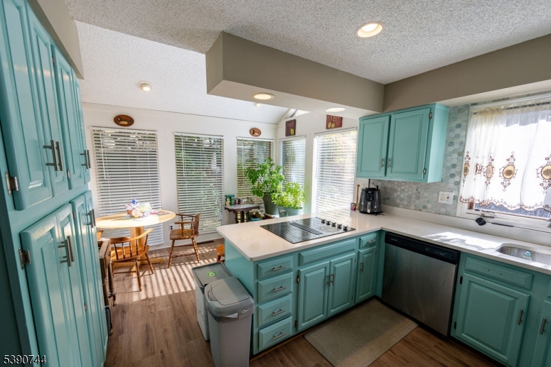 13 Village Way, Unit E7 Vernon, NJ 07462 - Photo 9 of 46 a kitchen with a sink and wooden cabinets