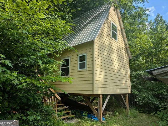 a backyard of a house with table and chairs