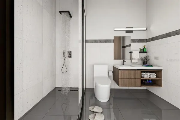 a bathroom with a sink toilet and shower