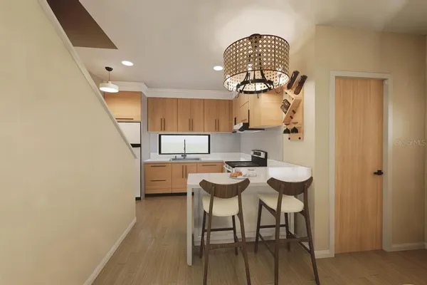 a view of dining room and kitchen with furniture wooden floor and a chandelier
