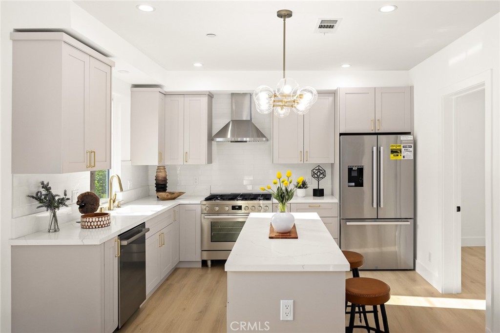 905 Sunset Boulevard, Unit A Arcadia, CA 91007 - Photo 12 of 35 a kitchen with a sink a refrigerator and white cabinets