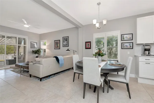 a living room with furniture a chandelier and a table