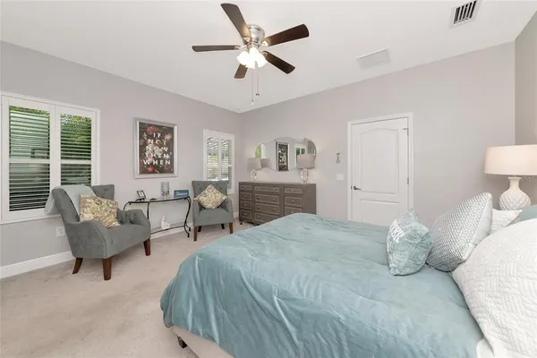a spacious bedroom with a bed and a couch
