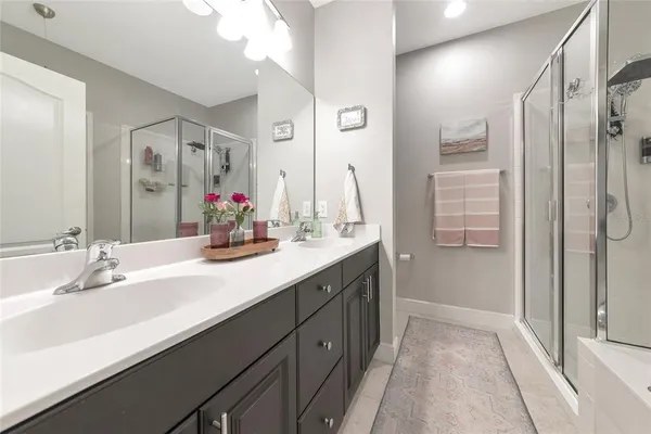 a bathroom with a double vanity sink mirror and double
