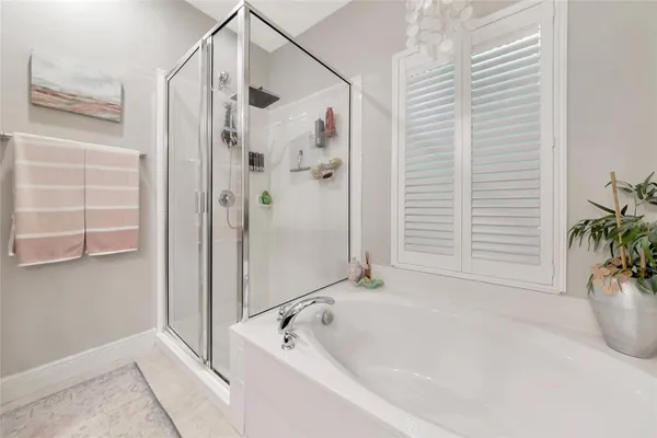 a white bath tub sitting next to a shower