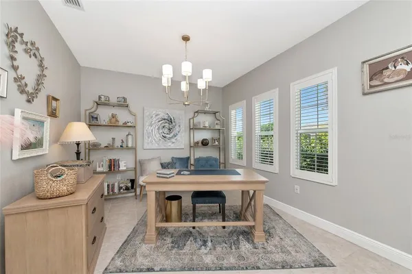 a view of a dining room with furniture and chandelier