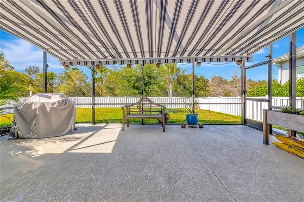 a view of a backyard with a table and chairs