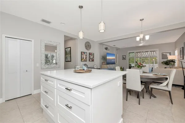 a view of living room with granite countertop furniture and a chandelier