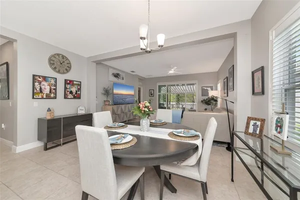 a view of a dining room with furniture a livingroom and chandelier