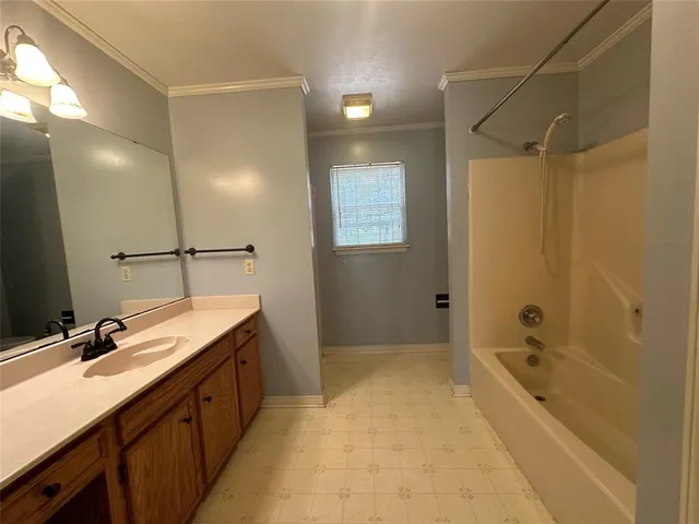 a bathroom with a tub sink shower and mirror