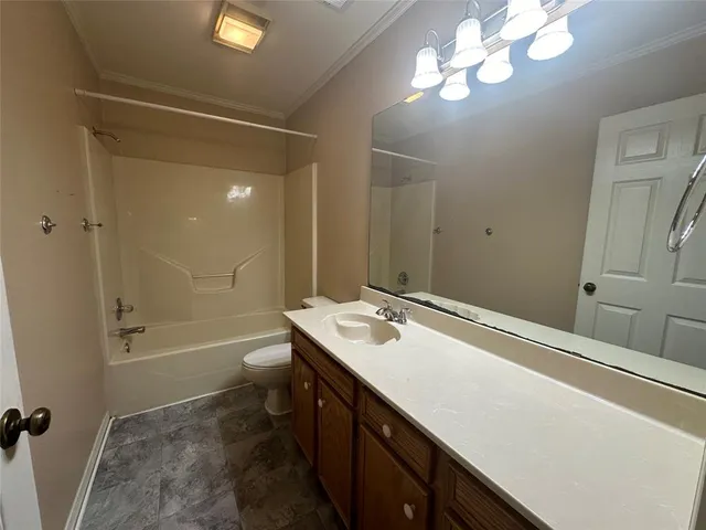 a bathroom with a sink a toilet a mirror and shower