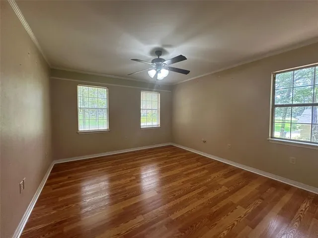 wooden floor in an empty room with a window