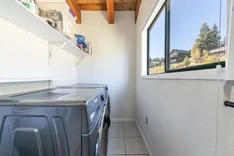 a utility room with a sink and a window