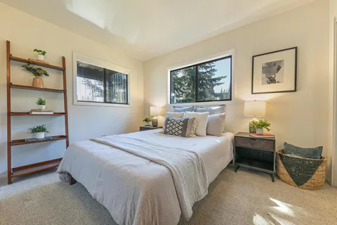 a large kitchen with a large window a sink and stainless steel appliances