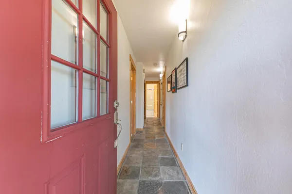 a kitchen with stainless steel appliances kitchen island granite countertop a stove a sink and a refrigerator