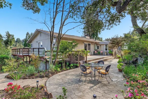 a view of a house with backyard and sitting area