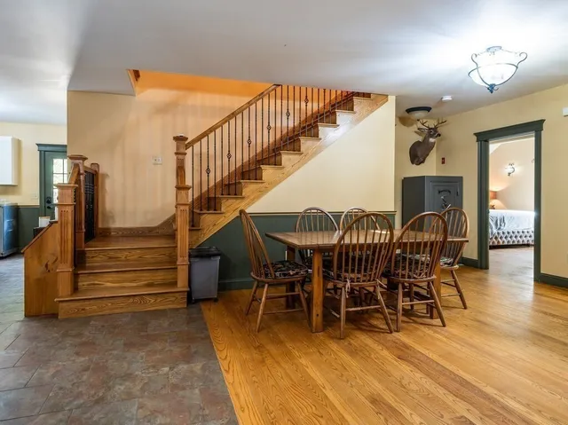 a view of dining room with furniture and wooden floor