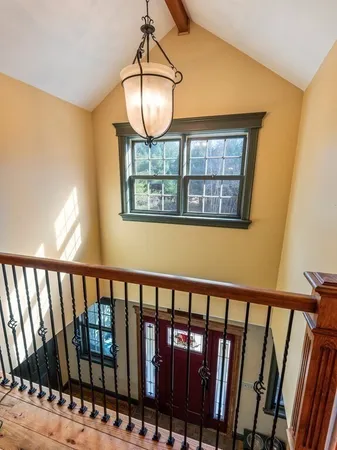 a view of staircase with railing and wooden floor